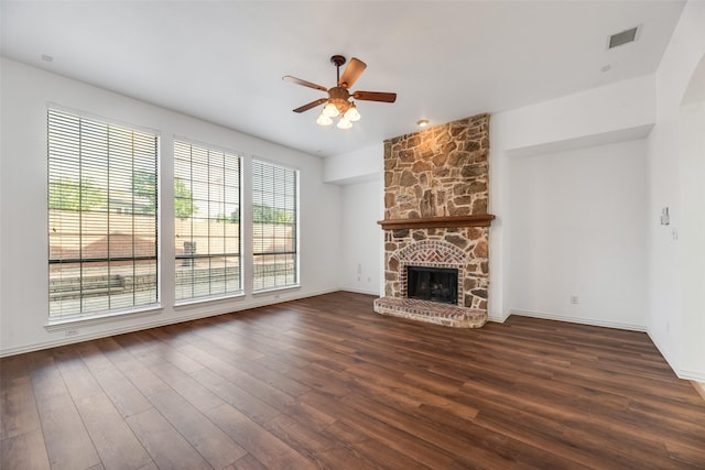 9328 Old Veranda Rd, Plano, TX 75024 - unfurnished living room featuring dark wood-style floors, a ceiling fan, a stone fireplace, and baseboards
