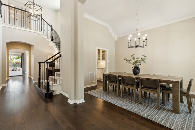 dining space featuring an inviting chandelier, dark wood-type flooring, and ornamental molding