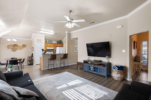 living room featuring dark hardwood / wood-style flooring, crown molding, vaulted ceiling, and ceiling fan with notable chandelier