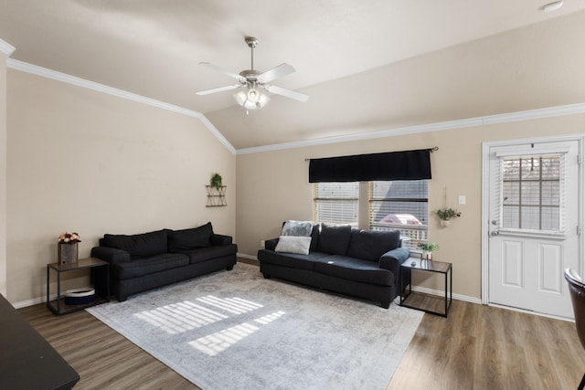 living room featuring crown molding, vaulted ceiling, wood-type flooring, and plenty of natural light