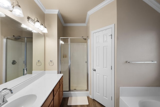 bathroom with crown molding, vanity, and shower with separate bathtub