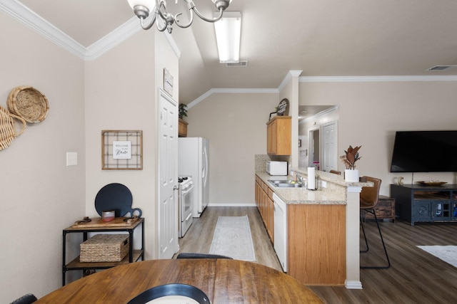 kitchen with crown molding, dark hardwood / wood-style floors, a breakfast bar area, and white appliances