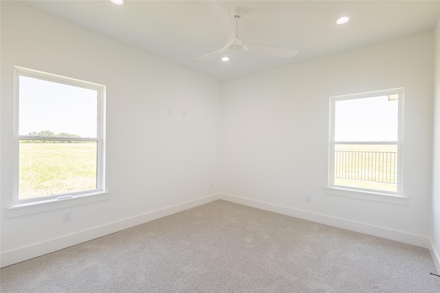 unfurnished room with light carpet and ceiling fan