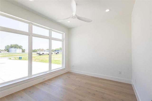 empty room with light hardwood / wood-style flooring and ceiling fan