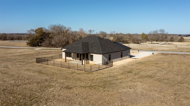 exterior space featuring a rural view and a lawn