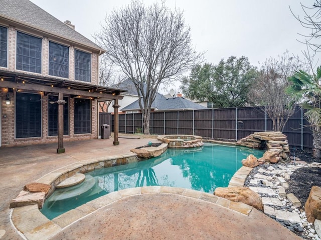 view of swimming pool featuring a patio and an in ground hot tub