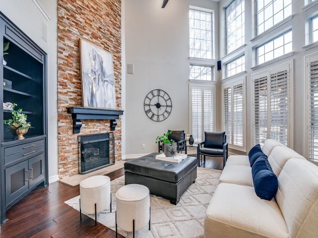 living room featuring a stone fireplace and hardwood / wood-style floors