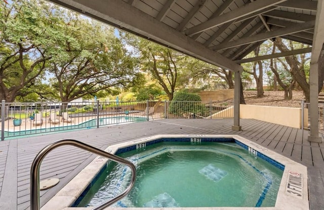 view of pool with a hot tub