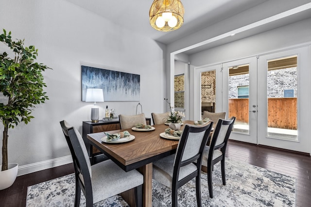 dining space featuring dark hardwood / wood-style flooring and french doors