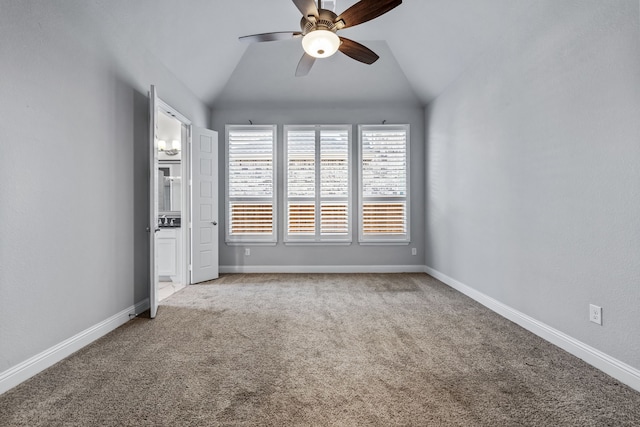 spare room featuring lofted ceiling, carpet floors, and ceiling fan