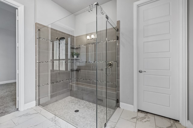 bathroom with a shower with door