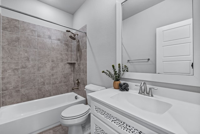 full bathroom with tiled shower / bath combo, vanity, and toilet