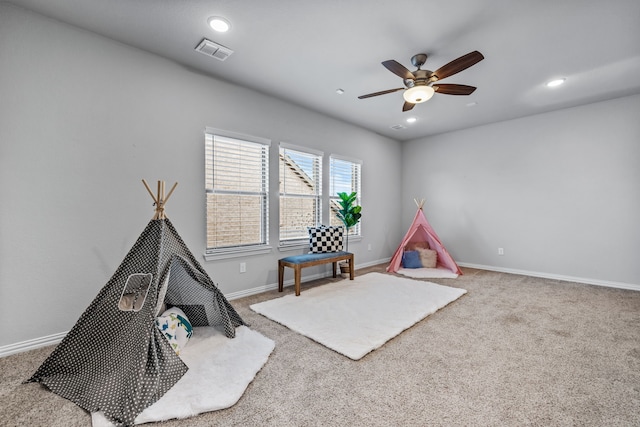 game room with ceiling fan and carpet flooring