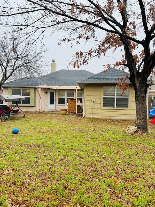 rear view of house with a lawn