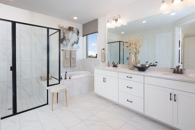 bathroom featuring vanity and separate shower and tub