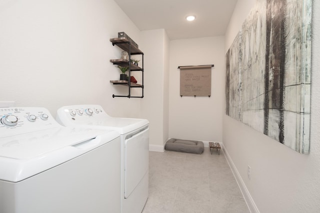 laundry room featuring separate washer and dryer and light tile patterned floors