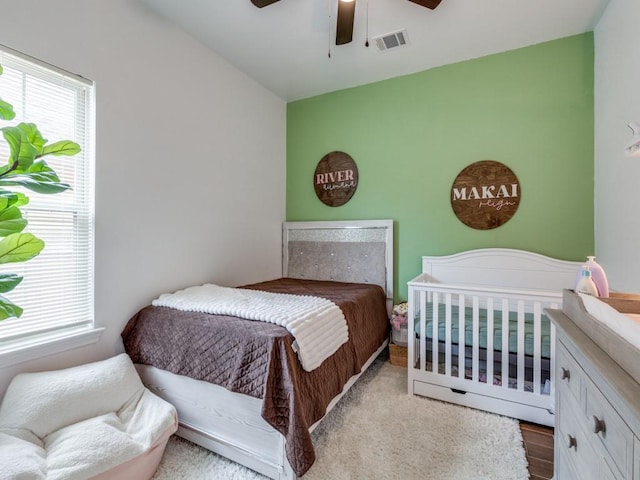 bedroom with ceiling fan and multiple windows