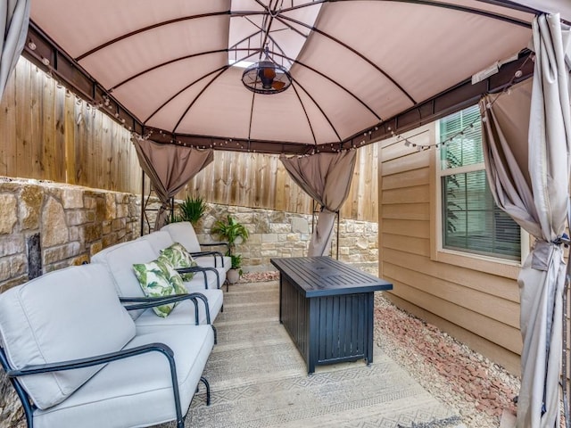 view of patio with an outdoor living space and a gazebo