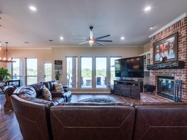 living room featuring ornamental molding, a brick fireplace, a wealth of natural light, and hardwood / wood-style floors