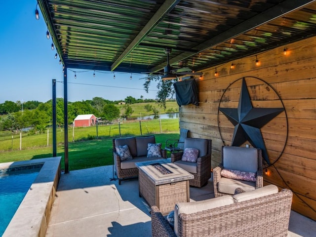 view of patio featuring a water view and an outdoor living space with a fire pit