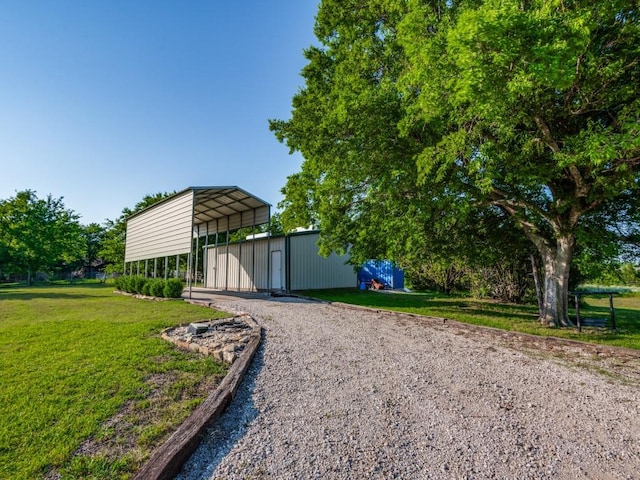 exterior space featuring a yard and a carport