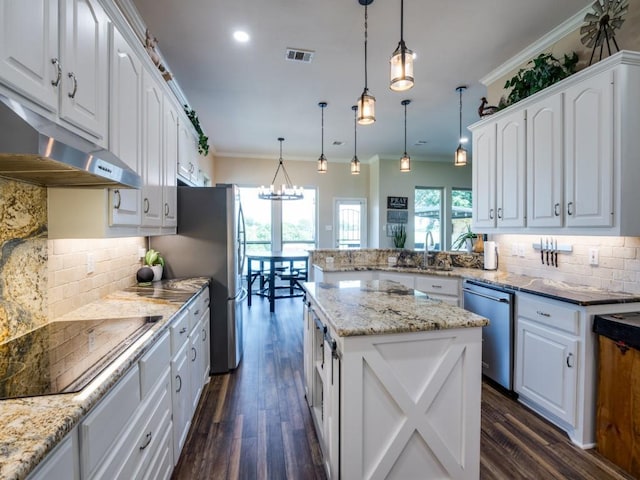 kitchen featuring white cabinetry, black electric cooktop, pendant lighting, and dishwasher