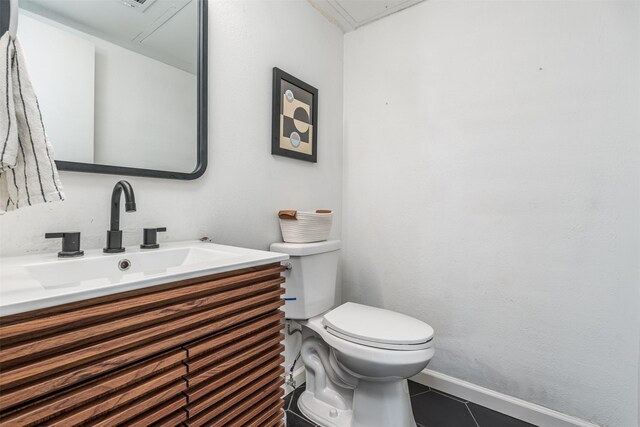 bathroom with tile patterned floors, vanity, and toilet