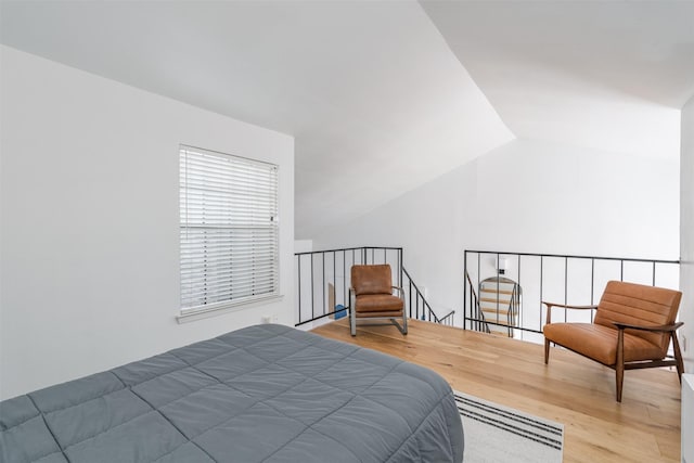 bedroom featuring lofted ceiling and wood-type flooring