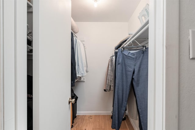 walk in closet with light wood-type flooring