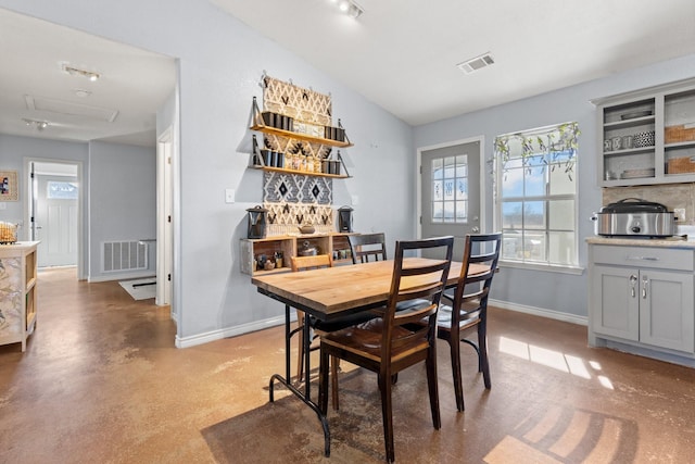 dining space featuring lofted ceiling