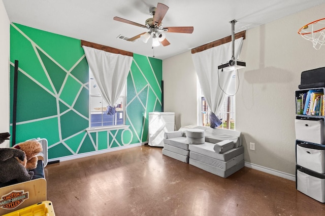 sitting room featuring concrete floors and ceiling fan