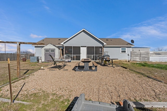 rear view of property featuring a sunroom