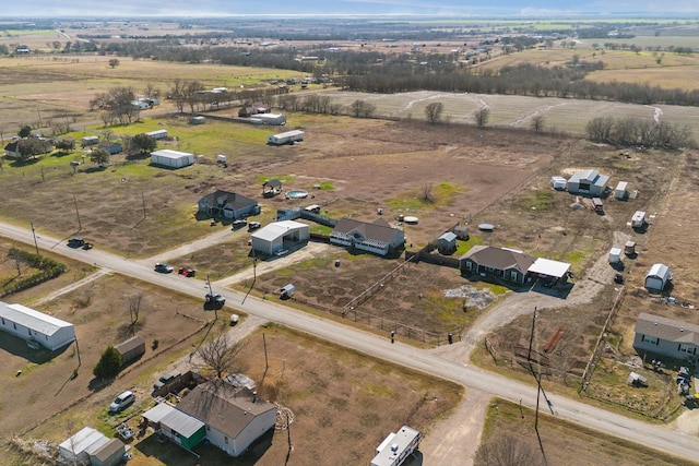 birds eye view of property with a rural view