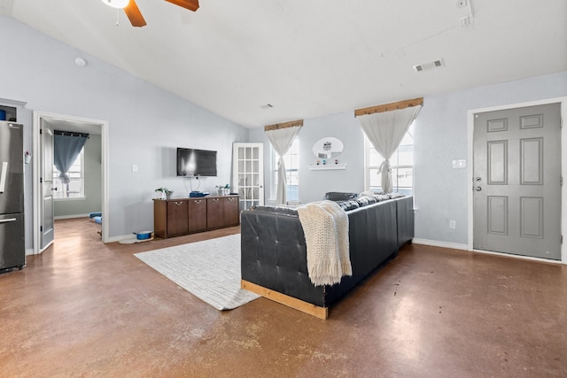 living room featuring vaulted ceiling, concrete floors, and ceiling fan