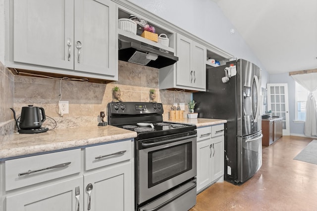 kitchen featuring light stone countertops, vaulted ceiling, appliances with stainless steel finishes, and decorative backsplash