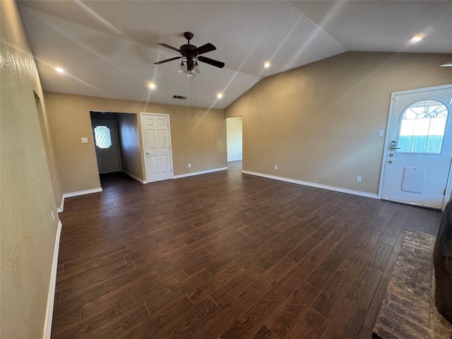 unfurnished living room with dark wood-style floors, visible vents, a ceiling fan, vaulted ceiling, and baseboards