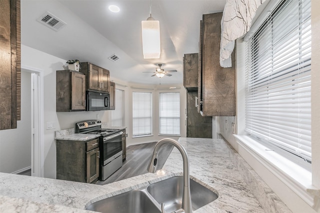 kitchen featuring sink, ceiling fan, light stone countertops, decorative light fixtures, and stainless steel electric stove