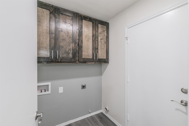 washroom with gas dryer hookup, dark hardwood / wood-style flooring, cabinets, washer hookup, and electric dryer hookup