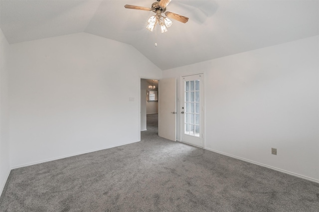 spare room featuring lofted ceiling, ceiling fan, and carpet