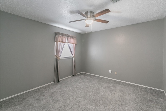 carpeted empty room featuring a textured ceiling and ceiling fan