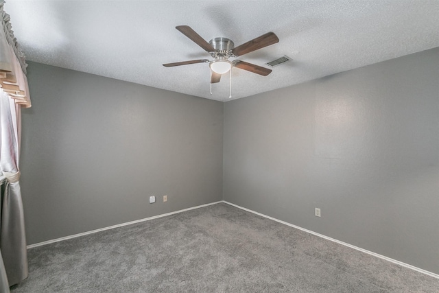 carpeted empty room featuring ceiling fan and a textured ceiling