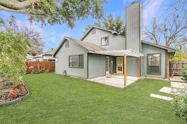 rear view of property featuring a yard and a patio