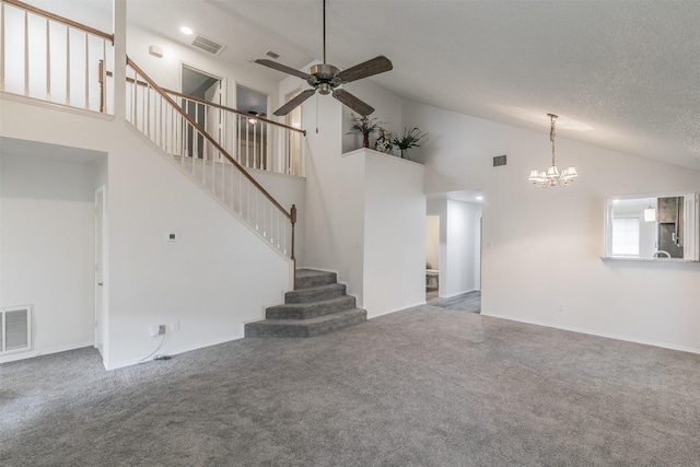 unfurnished living room with lofted ceiling, ceiling fan with notable chandelier, carpet, and a textured ceiling