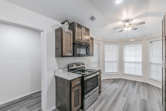 kitchen featuring stainless steel range with electric stovetop, dark brown cabinets, light hardwood / wood-style floors, and a healthy amount of sunlight