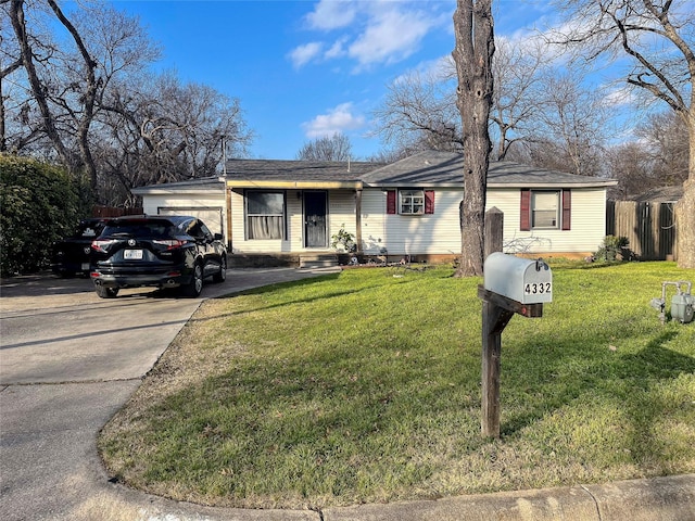 ranch-style home featuring a front yard, concrete driveway, and an attached garage