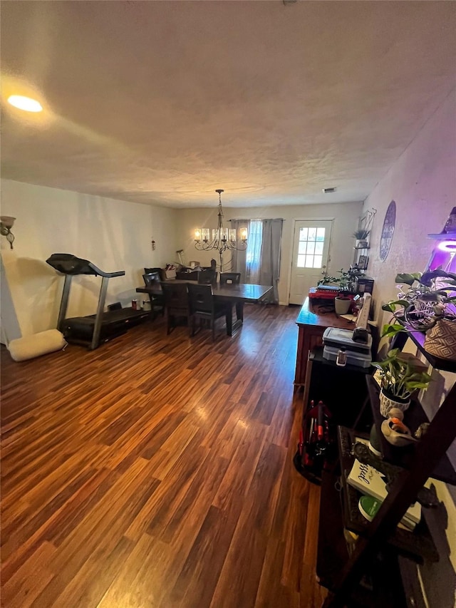 dining space featuring a notable chandelier and wood finished floors