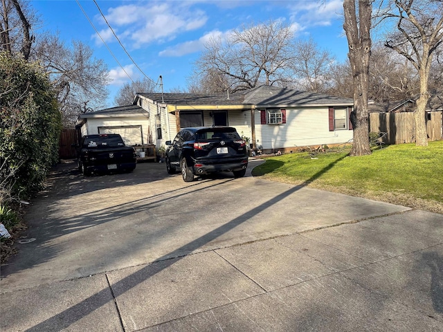 view of front of property with driveway, a front lawn, and fence