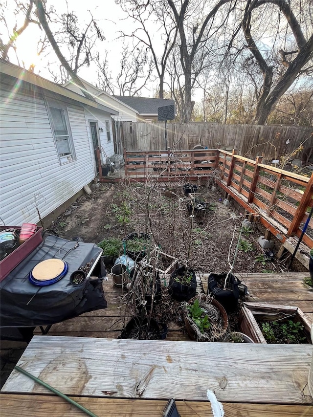 view of yard with a deck and fence