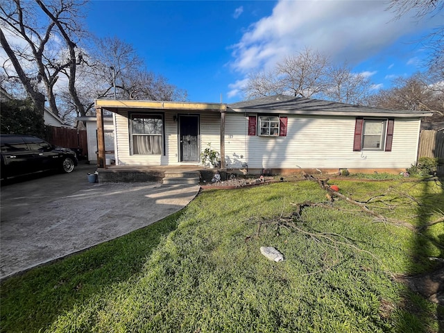 ranch-style house with covered porch, a front yard, and fence