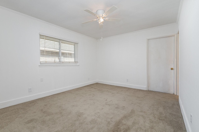 empty room featuring ceiling fan, light colored carpet, and ornamental molding